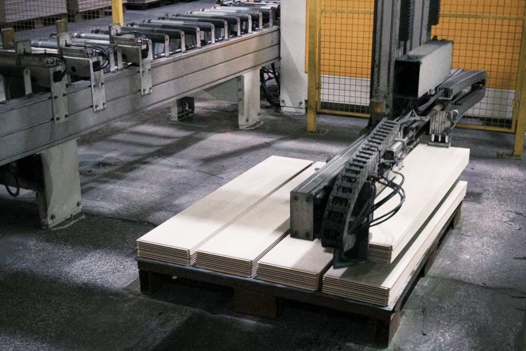 Flooring panels on an automated conveyor